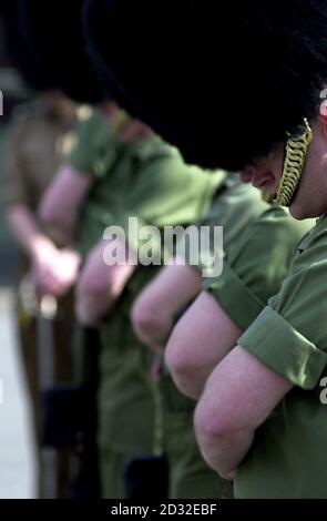 Members from Number 7 Company Coldstream Guards perform the reversed arm manoeuvre at Chelsea Barracks, west London,  during a rehearsal for the moving of the Queen Mother's coffin on Friday which will be taken from the Queen's Chapel at St James' Palace.  *...to Westminster Hall. The reversed arm salute has not been seen performed since the funeral of Sir Winston Churchill in 1965.  Stock Photo