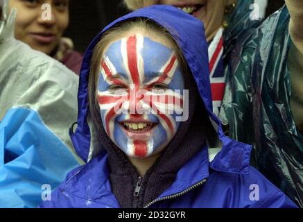 A young spectator with the Union Jack painted on her face waits with early morning spectators to see Britain's Queen Elizabeth II outside Buckingham Palace.   * The Queen and the Duke of Edinburgh will leave Buckingham Palace in a State Gold Coach for a thanksgiving service at St Paul's Cathedral, before returning to watch a parade in The Mall on the final day of the Golden Jubilee. Stock Photo
