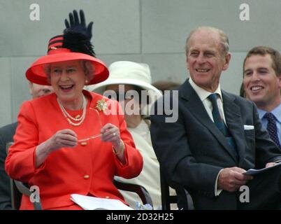 Britain's Queen Elizabeth II laughs as she and her husband, the Duke of Edinburgh, and other members of the Royal family watch a parade in The Mall as part of her Golden Jubilee celebrations. * Earlier the Queen had travelled to St Paul's Cathedral for a service of thanksgiving and attended a banquet in her honour at Guildhall. The parade, which lasted more than three hours, included bands from the Notting Hill Carnival, voluntary service personnel, children from the Chicken Shed Theatre Company, and a series of living rooms reflecting the five decades of her reign. After it finished the Ro Stock Photo