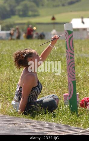 Louise Painter (19) of Wells at prepares some artwork at Glastonbury as people gather for the annual world-famous three-day music event that stretches over 900 acres in Somerset and is expected to attract some 105,000 people.   * NatWest, the bank that supplies cash machines for the festivals has said ATM transactions at the festival looked set to exceed cashpoint usage at busy London railway stations, Piccadilly Circus and Oxford Street.   Stock Photo