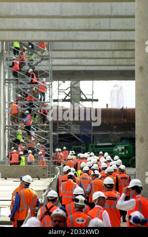 Workers for the Channel Tunnel Rail Link (CTRL), gather to watch as 'Annie', one of the two tunnel boring machines, begins work on the tunnel at one of the sites currently under construction as a new international station at Stratford.   *  The two boring machines will work on the 17.5km route from Stratford to St Pancras in central London, with Annie's sister 'Bertha' starting in six weeks time. Stock Photo