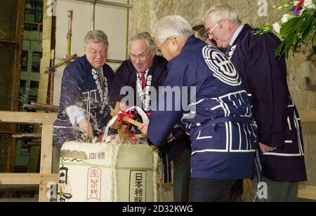 Bosses for the Channel Tunnel Rail Link (CTRL) including Project Director for Rail Link Engineering Roger Picard (left) and Managing Director of Union Railways (North) Walt Bell (2nd left) break into a barrel of sake - a Japanese rice liquor.  * ....  - as a good luck omen for the rail link at one of the sites currently under construction as a new international station, Stratford in east London. The two boring machines, Annie and Bertha, will begin work on the 17.5km route from Stratford to St Pancras in central London, with Annie starting today and Bertha beginning in six weeks time. Stock Photo