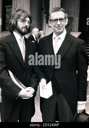 Mr George Mitchell, creator and leader of the Black and White Minstrels of TV and stage, leaving Buckingham Palace with musician son Robert, 25, after receiving the insignia of OBE from the Queen Mother. Stock Photo