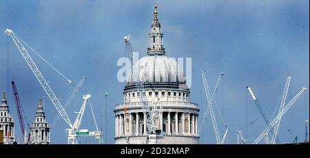 The dome of St Paul's Cathedral is surrounded by cranes working on construction in the City of London earlier September 2002.   *   New buildings and redevelopment - both for residents and business workers - stretching from Paddington Basin in the west to Canary Wharf in the east, mean a constantly changing skyline in the capital. Stock Photo