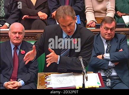 : Northern Ireland Secretary John Reid (left) and Deputy Prime Minister John Prescott (right) watch as Prime Minister Tony Blair gestures while he answers a question from Conservative party leader Iain Duncan Smith in the House of Commons,   *  during his weekly 'Question Time' with MPs. Stock Photo
