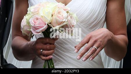 Olympic Gold medalist Jessica Ennis shows off her weddiing ring for the waiting media after she married Andy Hill in St Michael and All Angels Church, Hathersage, Derbyshire. Stock Photo