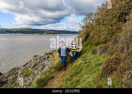 Walking the coastal path near Arnside in Cumbria Stock Photo