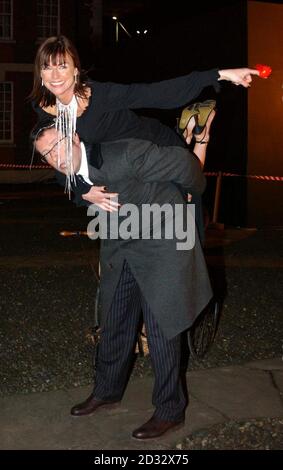 Celebrity student comedienne Doon Mackichan leaves on the back of TV presenter Rowland Rivron after being evicted from the Comic Relief does Fame Academy in north London. Stock Photo