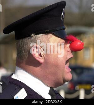 Drill instuctor Peter Clements from Stevenage in charge of police recruits wearing red noses in a rehearsal for their passing out parade on Friday March 14 2003 at Hendon Training School, North London. *..The new recruits have undertaken a range of activities to raise more than 7,000 for a local charity, North London Hospice. Charity events included a sponsered diet and a Cadbury's Creme Egg Eat-a-thon. Stock Photo