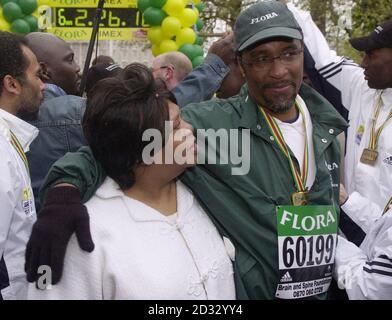 Former boxer Michael Watson, 38, celebrates with his mother, Joan, on The Mall in central London, after crossing the finishing line six days after setting off on the 26.2-mile 2003 London Marathon.    *... The former boxer, who was partially disabled after suffering a near fatal brain injury during the WBO super-middleweight title match with Chris Eubank in 1991, has managed to raise over  1 million for the British Brain and Spine Foundation through his marathon achievement.  Stock Photo