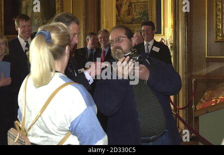 Prince Charles looks at a photograph of himself taken by a member of the public during a tour of Windsor Castle. In a bid to boost tourism, the heir to the throne took the tour of his mother's Castle with travel executives. Stock Photo