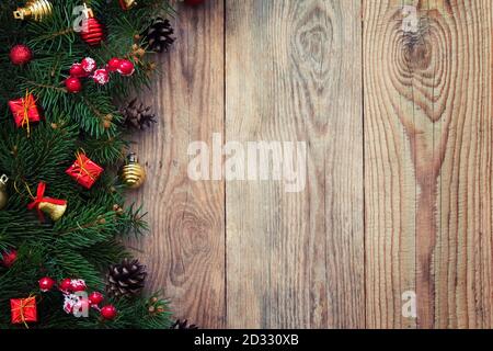 Christmas fir tree branches with toys on old wooden table Stock Photo