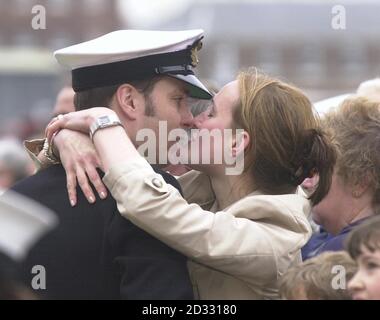 A sailor from HMS Ark Royal is greeted by a love one as the Royal Navy's flagship arrived home to the UK. Cheers, Union flags and tears of joy greeted the arrival as a crowd of up to 3,000 packed the jetty of Portsmouth's naval base  * ...  to give the crew a heroes' welcome.  A flypast of military helicopters and a military band heralded their arrival. The mighty aircraft carrier sailed from Portsmouth on January 11, leading Britain's largest maritime task-force since the Falklands War. The Ark Royal was due to head a long-planned Naval Task Group deployment to the Gulf and Asia Pacific regio Stock Photo