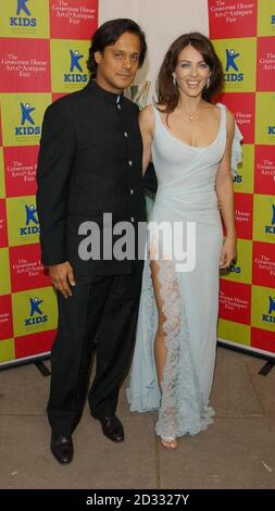 Actress Liz Hurley and boyfriend Arun Nayar, arriving at the Grosvenor House Hotel in London's Park Lane, for the Grosvenor House Art & Antiques Fair - charity gala evening. Stock Photo