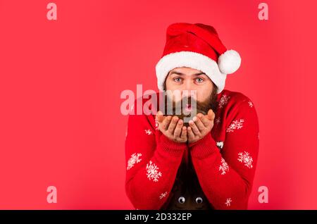 ready for party celebration. new year shopping idea concept. hipster enjoy the holiday. man in santa hat await christmas present. morning at Xmas. bearded man in sweater. copy space. Shopping Center. Stock Photo