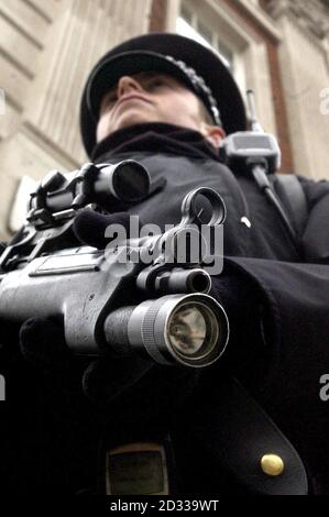 An armed Policeman stands on duty outside the American embassy in Grosvenor Square, London, ahead of the state visit by US President, George Bush. Security around the capital has been stepped up for the first state visit by an American leader since 1918.  Stock Photo