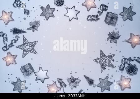 Christmas composition. Christmas balls, stars, gift boxes, ribbons and candles. New year decorations on blue background. Flat lay, top view, copy space Stock Photo