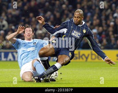 Manchester City's Robbie Fowler (left) battles with Groclin Dyskobolia's  Mariusz Pawlak, during the UEFA Cup, 2nd round, 1st leg match at The City  of Manchester Stadium. THIS PICTURE CAN ONLY BE USED