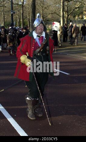 Andrew Newton of Sir William Pennymans Regiment, strikes a dashing pose as he waits to lead his Regiment up The Mall. He is wearing a polished Spanish Combe Morion, a type of helmet still seen during the early part of the Civil War, two wheel-lock carbine pistols tucked into his belt, a sword and a replica 17th century walking stick. The King's Army has held this march, to commemorate the execution of Charles I, in Central London on the last weekend in January for the past 32 years, and it is now recognised as a Custom of London. Stock Photo