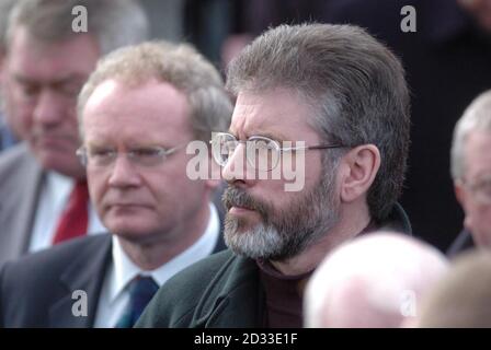 Sinn Feins' Martin McGuinness (left) and Gerry Adams at Eglish parish church, Co Tyrone, Northern Ireland, for the funeral of Tyrone GAA star, Cormac McAnallen, who died suddenly of a heart infection last week. Tens of thousands of people from all corners of Ireland arrived in the tiny village for the funeral of gaelic football's brightest young star.  Stock Photo