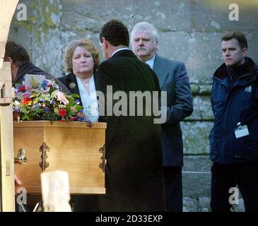 Mr and Mrs Holcroft, the parents of Rachel Whitear, following the post-mortem examination, outside the church in Withington, Herefordshire, as Miss Whitear's casket was brought back to the church in a hearse led by a police motorcyclist for the re-internment ceremony. The family thanked the team from Wiltshire Police, West Mercia Constabulary and all those professionals for the very patient and dignified way they have carried out their difficult task over the last couple of days.  28/03/04: Mrs Holcroft has spoken of her hopes to finally find out how she died in the wake of the traumatic exhum Stock Photo