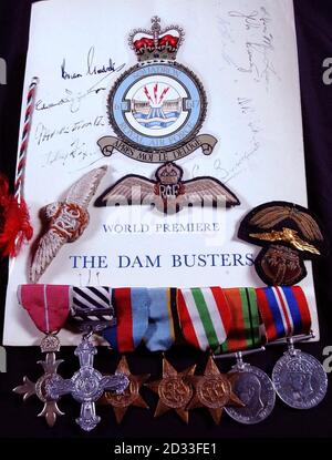 A collection of medals from a member of the famous 617 'Dam Busters' squadron Group Captain Ivan Whittaker that are to be auctioned at Spinks in Bloomsbury, London, it was announced. Left to right are the OBE, DFC, 1939-1945 Star, Air Crew Europe Star, Italy Star, Defence Medal and The War medal. A signed programme for the world premiere of The Dam Busters film and other air force decorations are also for auction. 30/04/2004: A Distinguished Flying Cross awarded to Dam Buster Ivan Whittaker who retired from the RAF as a group captain in 1974, but died five years later and remains the only f Stock Photo