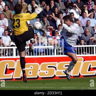 Hartlepool's scorer Adam Body takes on Plymouth 'keeper Luke McCormick, during the Nationwide Division Two match at Victoria Park, Hartlepool, Saturday May 1, 2004.  THIS PICTURE CAN ONLY BE USED WITHIN THE CONTEXT OF AN EDITORIAL FEATURE. NO UNOFFICIAL CLUB WEBSITE USE. Stock Photo