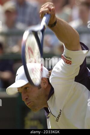 Great Britain's Greg Rusedski in action against Rainer Schuettler from Germany at The Lawn Tennis Championships in Wimbledon, London. Stock Photo
