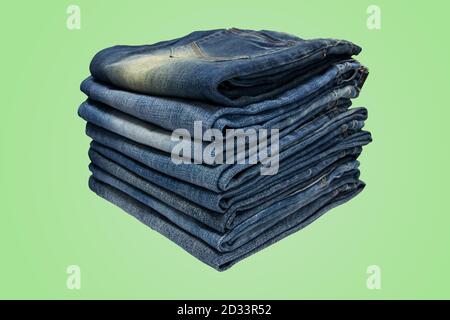Stack of blue jeans long legs for men and women isolated on pastel color background with clipping path. Stock Photo