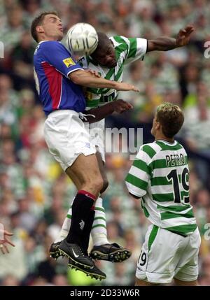 Celtic's Dianbobo Blade in mid-air battle against Rangers' Ronald de Boer (left) during the Tennent's Scottish Cup final match between Celtic and Rangers at Hampden Park, Glasgow. Stock Photo