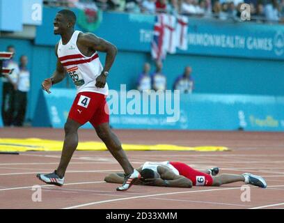 England's Dwain Chambers limps passed a prone Mark Lewis-Francis as both English sprinters pulled up in the men's 100 metres at the Commonwealth games. Stock Photo