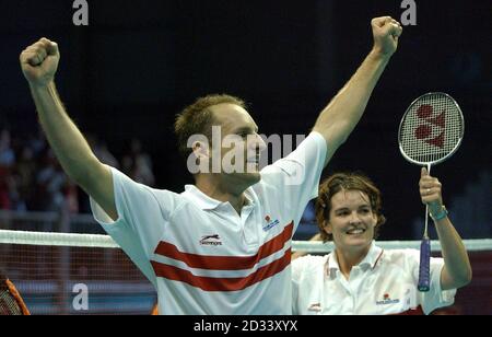 England's Simon Archer and Jo Goode celebrate winning the gold medal in badminton at the Bolton Arena, during the XVII Commonwealth Games. Stock Photo