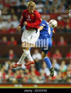 Manchester United's David Beckham (left) wins a header over Zalaegerzeg's Tamas Szamosi during the UEFA Champions League, third qualifying round, second leg game at Old Trafford, Manchester. Stock Photo