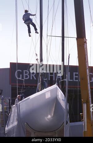 Great Britain's America's Cup team work on their masts in 'Syndicate Row' in Auckland's Viaduct Harbour with the hull shrouded by a cloth skirt to hide its keel and rudder from competing teams. * The nine challenging teams have been carrying out last minute trials in the Hauraki Gulf before the official opening ceremony for the Louis Vuitton Cup tomorrow in New Zealand's city of sails. The purpose of the Louis Vuitton Cup is to whittle the teams down to just one which then goes on to challenge the holders, Team New Zealand, for the America's Cup in February 2003. The millions of dollars spent Stock Photo