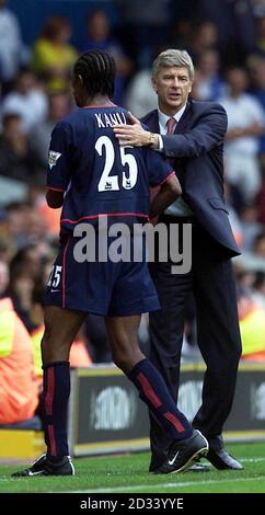 Arsenal's double goal scorer, Kanu receives a pat on the back from manager Arsene Wenger (right) after being taken off, during their FA Barclaycard Premiership match at Leeds' Elland Road ground. Arsenal defeated Leeds United 4-1.  THIS PICTURE CAN ONLY BE USED WITHIN THE CONTEXT OF AN EDITORIAL FEATURE. NO WEBSITE/INTERNET USE UNLESS SITE IS REGISTERED WITH FOOTBALL ASSOCIATION PREMIER LEAGUE.  Stock Photo