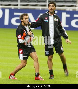 Juventus striker Alessandro Del Piero, center, followed by teammate Giorgio  Chiellini, left, with other teammates, warms-up next to an Italian Serie B  second division sign, at bottom, before the start of the