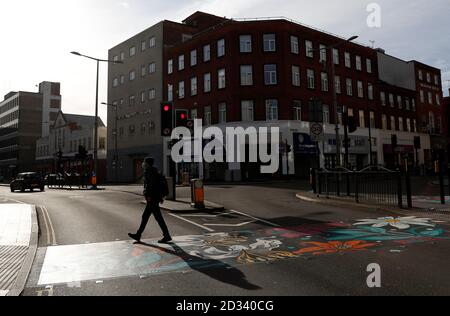 Leicester, Leicestershire, UK. 7th October 2020. A man walks on pedestrian crossing redesigned with colourful coverings 100 days since the UKÕs first local coronavirus pandemic lockdown was announced in the city. Credit Darren Staples/Alamy Live News. Stock Photo