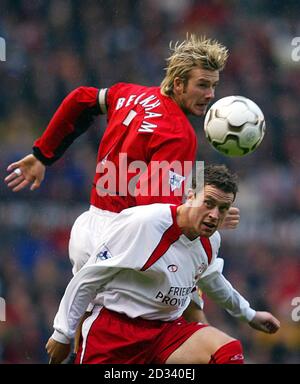 Manchester United's David Beckham (top) in action against Wayne Bridge of Southampton during the FA Barclaycard Premiership match at Old Trafford, Manchester. 17/11/02 Beckham will be sidelined for two to three weeks after tests revealed he is suffering from fractured ribs, it was confirmed. Beckham, who is thought to have picked up the injury in the Premiership win over Southampton, played in last Wednesday s Champions League victory over Bayer Leverkusen. But he was in pain after the match and tests revealed the injury to his ribs. A United spokesman confirmed that Beckham would be missing Stock Photo