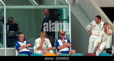 EDITORIAL USE ONLY - NO COMMERCIAL USE:  England coach Duncan Fletcher (back left) with David Graveney, Chairman of Selectors await news of injured bowler Simon Jones, during the First Test at the Gabba Cricket ground, Brisbane, Australia. Stock Photo