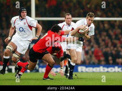 England's Will Greenwood breaks the tackle of Wales' Gavin Thomas, during their RBS 6 Nations Championship match at the Millennium Stadium. Stock Photo