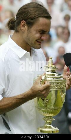EDITORIAL USE ONLY, NO MOBILE PHONE USE. Roger Federer from Switzerland cries holding the trophy following his victory over Mark Philippoussis from Australia in the men's final 7:6/6:2/7:6 at the All England Lawn tennis Championships at Wimbledon. Stock Photo