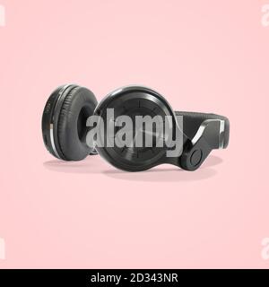 Black wireless headphone isolated on beautiful pastel color background, with clipping path. Stock Photo