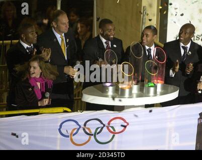 Teenage actress Emma Watson, who plays Hermione Grainger in the Harry Potter films, helps Olympic gold medal winners (l to r) Mark Lewis-Francis, Sir Steve Redgrave, Darren Campbell, Jason Gardner and Marlon Devonish, to turn on the traditional Christmas lights in London's Oxford Street Stock Photo