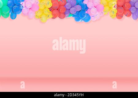Group of multi colored balloons for decoration in celebrations of various important days on the beautiful pastel pink color background. Stock Photo