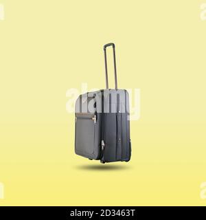 Black suitcase isolated on beautiful pastel color background, with clipping path. Stock Photo