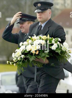 Strathclyde fire fighters hold flowers for two-year-old Andrew Morton at St Dominic's church. Stock Photo