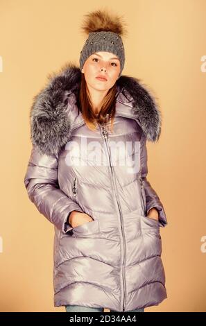 Faux fur. Fashion girl winter clothes. Fashion coat and hat. Fashion trend. Warming up. Casual winter jacket slightly more stylish and have more comfort features such as larger hood fur trim on hood. Stock Photo