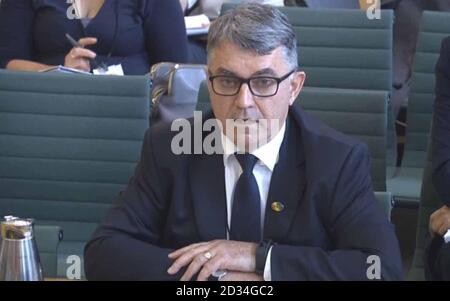 RMT general secretary Mick Cash in front of the Transport Select Committee at the Houses of parliament, London talking about the industrial action with Southern Railway over the changing roles of train guards. Stock Photo