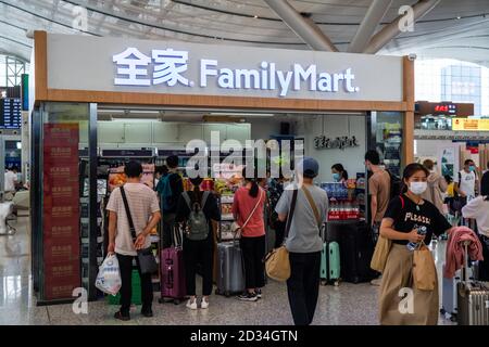 Customers are seen at a FamilyMart convenience store in Shenzhen North Railway Station. Stock Photo