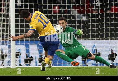 Juventus' Paulo Dybala scores his side's second goal during the UEFA Champions League round of 16, second leg match at Wembley Stadium, London. Stock Photo